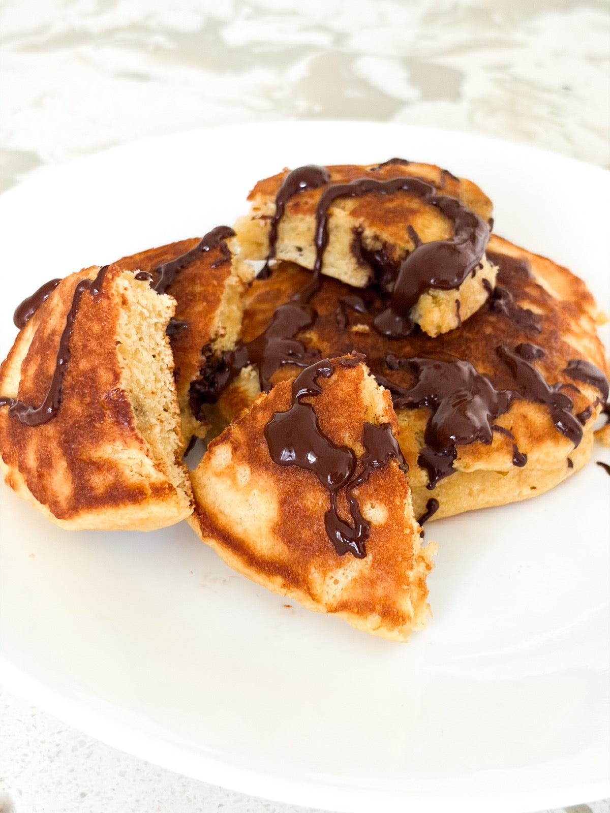 Pancakes drizzled with melted chocolate