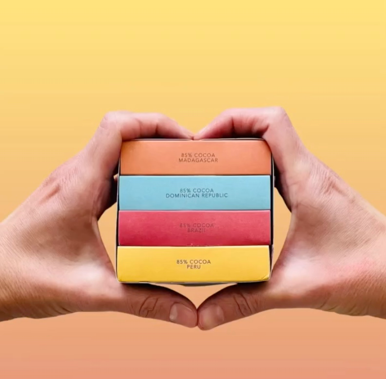 Nibble single-origin chocolate bars held between two hands